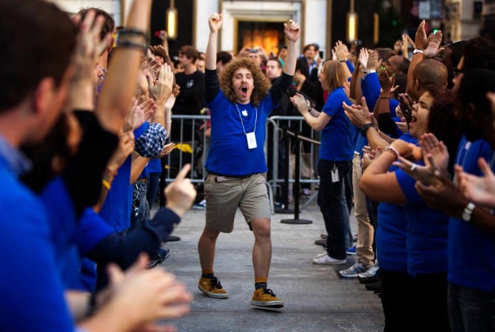 Apple employees celebrate the release of the Apple iPhone 5 phone outside of the Apple Store on 5th Avenue in New York, September 21, 2012. Apple fans queued around city blocks worldwide on Friday to get their hands on the new iPhone 5 - but grumbles about inaccurate maps tempered the excitement. REUTERS/Lucas Jackson (UNITED STATES - Tags: BUSINESS TELECOMS)