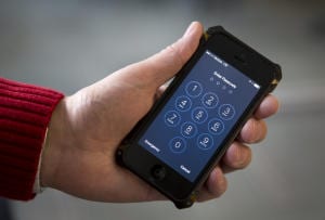 An iPhone is seen in Washington, Wednesday, Feb. 17, 2016.  The San Bernardino County-owned iPhone at the center of an unfolding high-profile legal battle between Apple Inc. and the U.S. government lacked a device management feature bought by the county that, if installed, would have allowed investigators easy and immediate access.  (AP Photo/Carolyn Kaster)